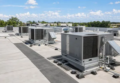 Commercial rooftop package units and ductwork on a flat roof