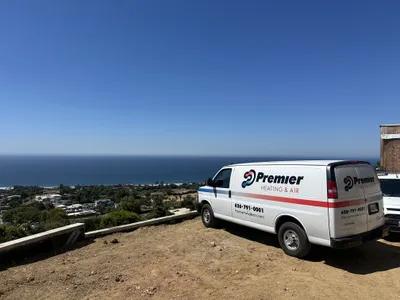 Premier Heating & Air service van parked overlooking the Los Angeles coastline